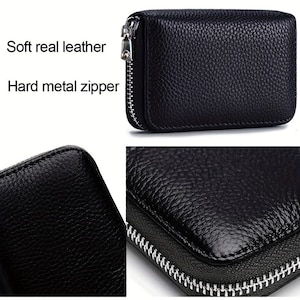 May include: Black leather zippered wallet with a hard metal zipper. The wallet has a textured surface and a silver zipper.