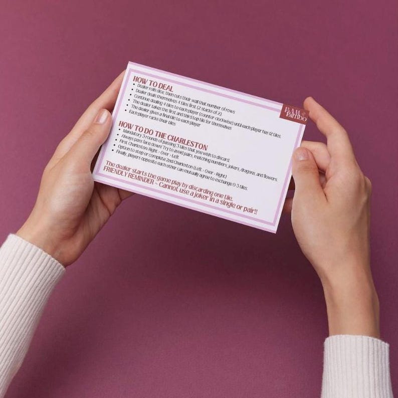 May include: A pink card with instructions for playing a card game called "The Charleston". The card has the title "How to Deal" and "How to Do The Charleston" with instructions for each.