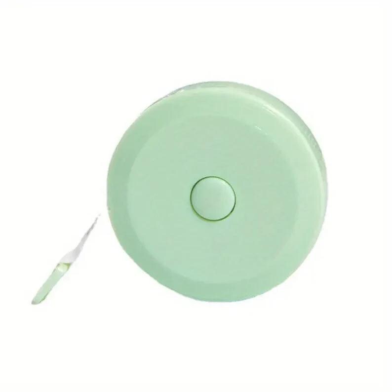 May include: A light green retractable tape measure with a white tape. The tape measure is round and has a button on the front.