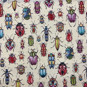 May include: A beige fabric with a repeating pattern of colourful insects. The insects are stylised and have a variety of colours, including red, blue, green, yellow, and black.