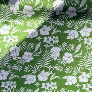 May include: Green fabric with a white floral pattern featuring hibiscus flowers and tropical leaves. The design is a repeating pattern of stylized flowers and foliage, creating a vibrant and summery aesthetic.