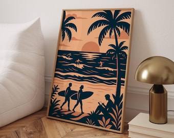 May include: A framed art print featuring a beach scene with surfers, palm trees, and a sunset. The artwork uses a color palette of orange, navy blue, and tan. Two figures walk with surfboards, while another person reads. The print is displayed on a wooden floor.