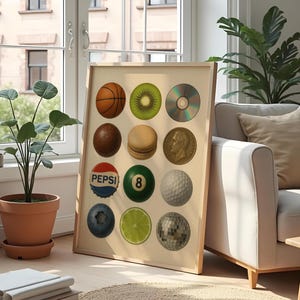 May include: A framed print featuring a collection of various objects, including a basketball, kiwi, CD, chocolate ball, macaron, coin, Pepsi bottle cap, 8-ball, golf ball, blueberry, lime, and disco ball. The print is displayed near a window and a potted plant.