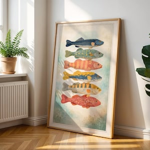 May include: A framed art print displaying six illustrated fish in various colours. The fish are depicted in blue, green, orange, and yellow, with detailed patterns. The artwork is displayed in a room with a window and a potted plant.