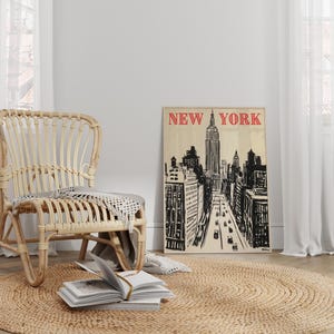 May include: A wicker chair with a woven seat and back sits in a room with a large window and a poster on the wall. The poster is a black and white illustration of the New York City skyline with the text "NEW YORK" in red letters.