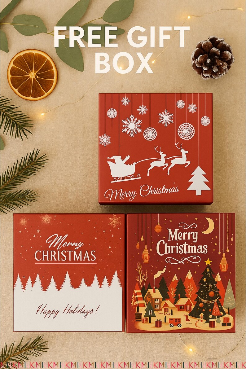 Three red Christmas-themed gift boxes with festive prints displayed on a beige background. Surrounding details include pinecones, orange slices, and fairy lights, highlighting the “Free Gift Box” offer for ornaments.
