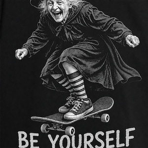Funny witch PNG showing a cheerful elderly Halloween witch skateboarding in a dynamic crouched pose while wearing a pointed hat, flowing black dress, striped socks and sneakers above the bold quote “BE YOURSELF.” The energetic black-and-white artwork uses detailed retro engraved halftone and mixes witchy humor, positive self-expression and skater attitude. Ideal for funny Halloween shirts, witch lover gifts, cool grandma apparel, spooky season outfits, sublimation, DTF and DTG printing projects.