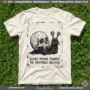 May include: Cream-colored t-shirt featuring a black and white graphic of a skull-snail hybrid. The design includes the text "SLOWLY MOVING TOWARDS THE INEVITABLE OBLIVION." The shirt is made of a soft material and has short sleeves.
