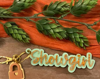 Sparkle trendy orange and green showgirl keychain and charm. Trendy perfect for any wardrobe.