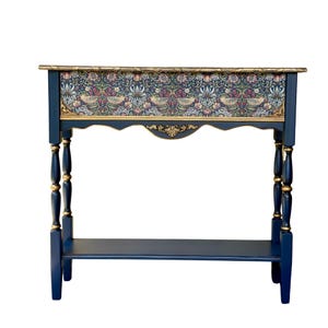 May include: A white ceramic mug with a black handle and the text "But First, Coffee" in a handwritten style. The mug is on a white surface. The mug is 4 inches tall.