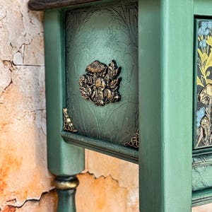 Unique green console table side view featuring raised sculpted mushrooms in golden tones on a dramatic deep green background, handcrafted accent furniture, luxury woodland inspired design.