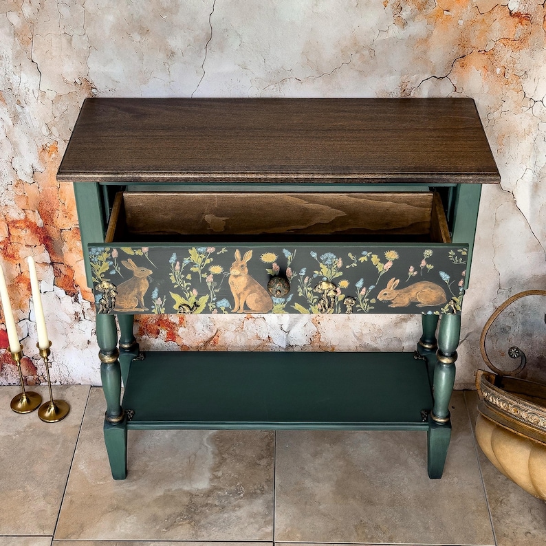 Unique hand-painted green console table with open drawer, decorative floral and animal artwork inside, ornate carved trim, artisan functional art furniture for entryway or living room.