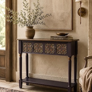 May include: A dark purple console table featuring four drawers with ornate gold-toned carved floral panels and ring pulls. The table has a rectangular wooden top, four straight legs with gold accents, and a lower shelf for additional storage space.