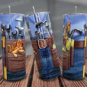 May include: A blue and white patterned tumbler with a brown leather tool belt and various tools, including a hammer, wrench, and pliers. The tumbler is designed to look like a person wearing a tool belt.