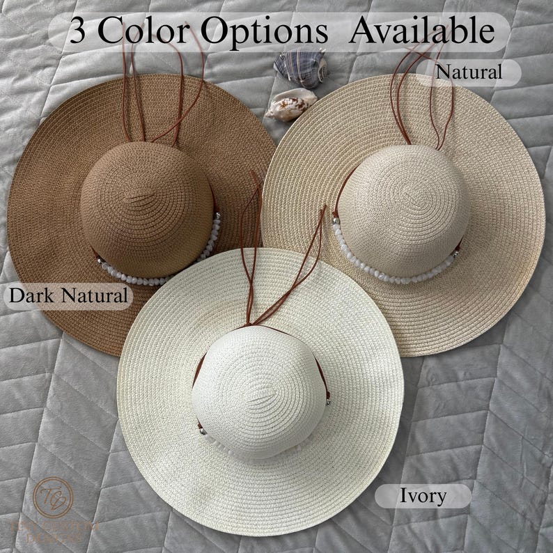 May include: Three wide-brimmed sun hats in dark natural, natural, and ivory colors. Each hat features a round crown, a chin strap, and a decorative beaded accent. The text "3 Color Options Available" is at the top.