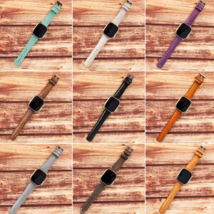 May include: Nine different colored leather watch bands for a smart watch. The bands are shown on a wooden background.