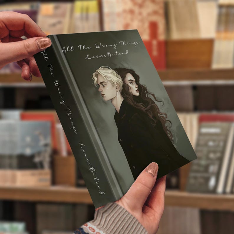 May include: A book cover with the title "All The Wrong Things" and the author's name "LovesBitca8" in white text. The cover features a drawing of a person with white hair and a person with dark hair, side by side, on a dark green background.