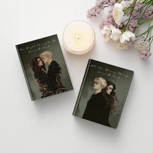 May include: Two books with illustrations of a couple, one embracing and the other looking away. The book on the left is titled "The Right Thing To Do" and the book on the right is titled "All The Wrong Things". A lit candle and flowers are also in the image.