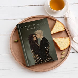 May include: A hardcover book titled "The Right Thing To Do" with the subtitle "LovesBites8" featuring an illustration of two people embracing. The book is on a wooden tray with slices of cake and a cup of tea.