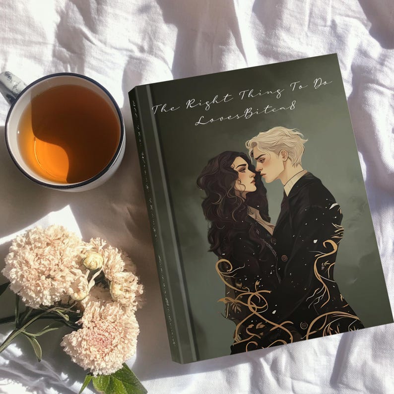 May include: A book titled "The Right Thing To Do" with a romantic illustration of two people. A cup of tea and a bouquet of flowers are next to the book on a white surface. The book cover is dark green with gold accents.