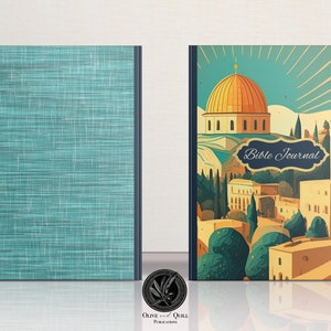 May include: A teal blue journal with a textured cover. The front cover features an illustration of a cityscape with a golden dome building and the text "Bible Journal".