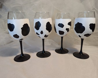 PAIR of cow print wine glasses with black stems