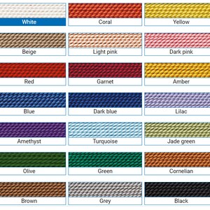 May include: A color chart with 18 different colors of embroidery floss. The colors are arranged in three rows of six colors each. The colors are: white, coral, yellow, beige, light pink, dark pink, red, garnet, amber, blue, dark blue, lilac, amethyst, turquoise, jade green, olive, green, cornelian, brown, grey, and black.