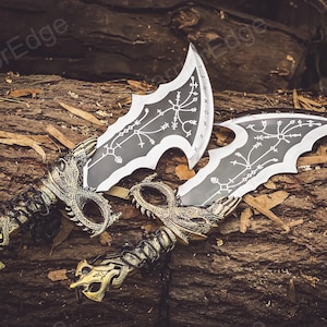May include: Two decorative swords with black blades and gold handles. The blades have intricate designs and the handles are shaped like dragon heads.