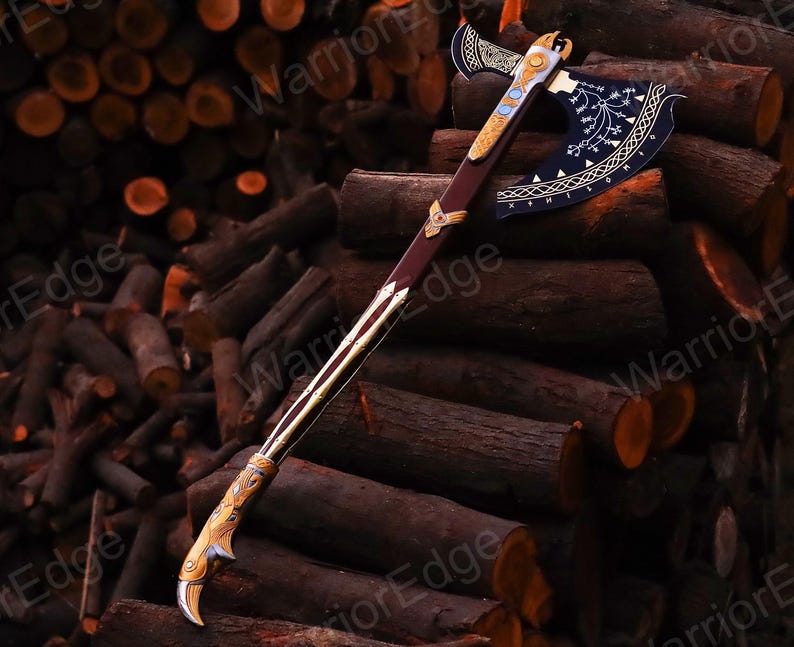 May include: A decorative axe with a black blade and gold accents. The axe has a wooden handle and a curved blade with intricate designs. The axe is resting on a pile of logs.