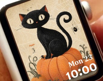 May include: A white smartwatch displays a Halloween-themed image. A black cat sits atop an orange pumpkin, with a spider and cobweb background. The watch face shows the date, Monday the 23rd, and the time, 10:00.
