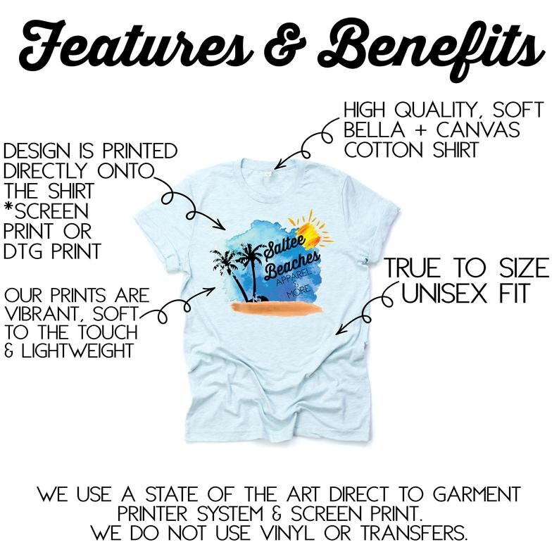 May include: A light blue t-shirt with a watercolor design of palm trees, a beach, and a sun. The text "Saltee Beaches Apparel & More" is printed on the shirt. The shirt is made of high quality, soft Bella + Canvas cotton. The design is printed directly onto the shirt using a state-of-the-art direct to garment printer system and screen print. The shirt is true to size and has a unisex fit.