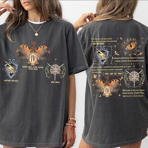 a woman wearing a black t - shirt with a picture of a butterfly on it