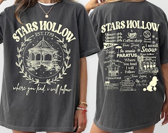 May include: A gray t-shirt with a graphic print of a gazebo and the text "Stars Hollow Est. 1779 where you lead, I will follow". The back of the shirt has a graphic print of a town scene with the text "Stars Hollow Gilmore girls Gilmore girls Gilmore girls Coffee shop No cell Phones I smell Team Jess In omnia Paratus Stars Hollow Where you lead I will follow Team Logan Oy, the world of good"