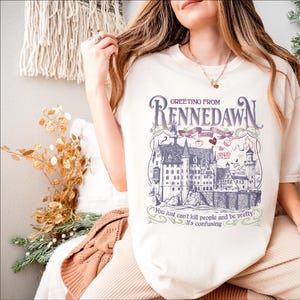 a woman sitting on a chair wearing a t - shirt