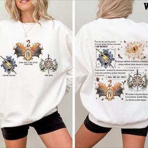 a woman wearing a white sweatshirt and shorts