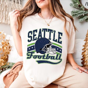 a woman wearing a seattle football t - shirt