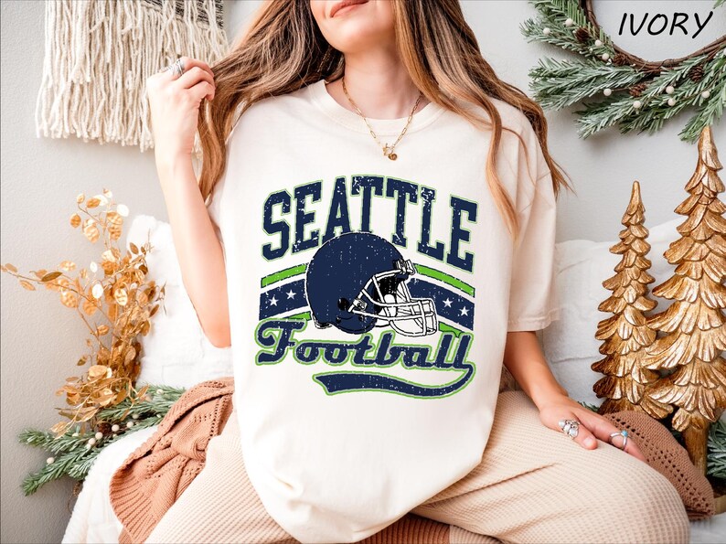 a woman wearing a seattle football t - shirt