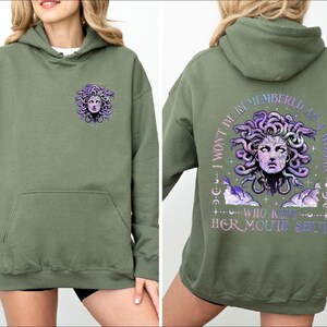 a woman wearing a green hoodie with an image of a woman's face