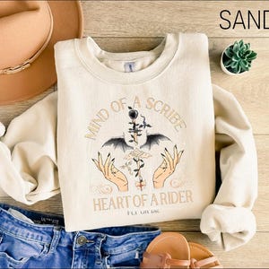 a pair of jeans and a t - shirt on a wooden floor