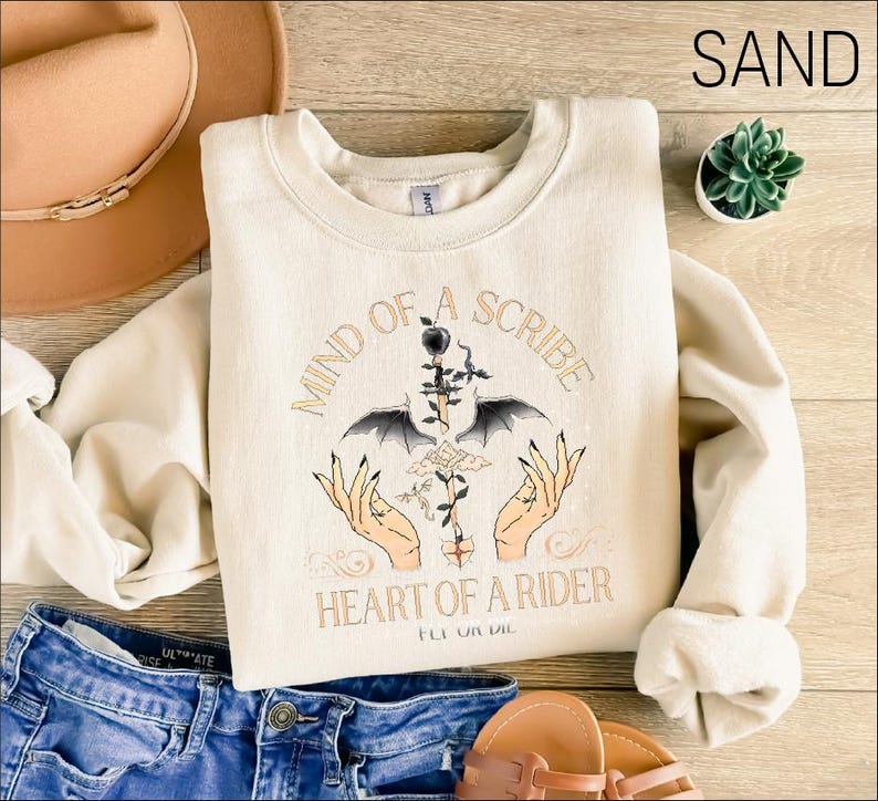 a pair of jeans and a t - shirt on a wooden floor