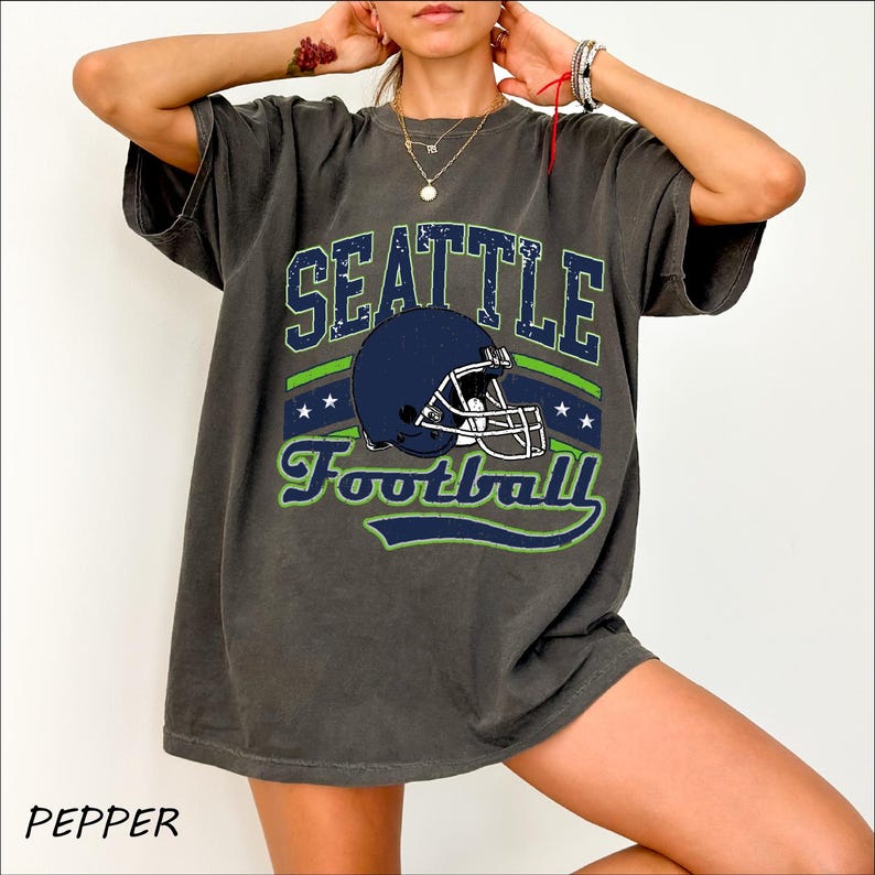 a woman wearing a seattle football t - shirt