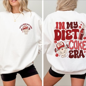 a woman wearing a sweatshirt that says in my diet coke era