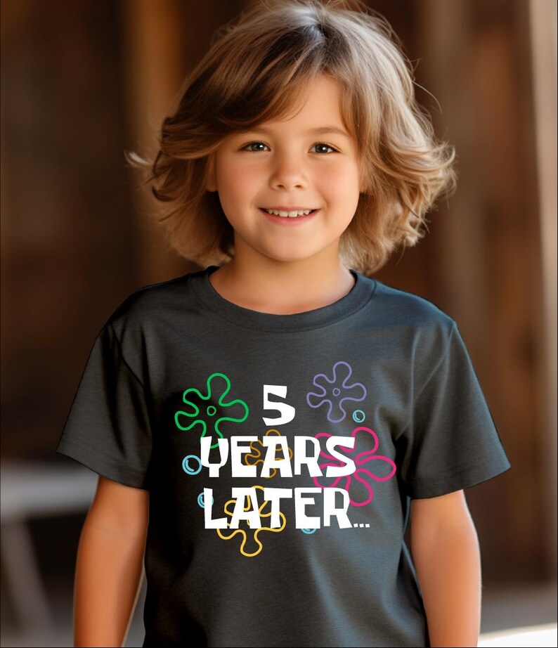 May include: A dark gray t-shirt with a white graphic that says "5 years later" surrounded by colorful cartoon starfish.