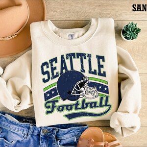 a sweater with a football helmet on it