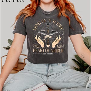 a woman wearing a t - shirt that says land of a spirit heart of a