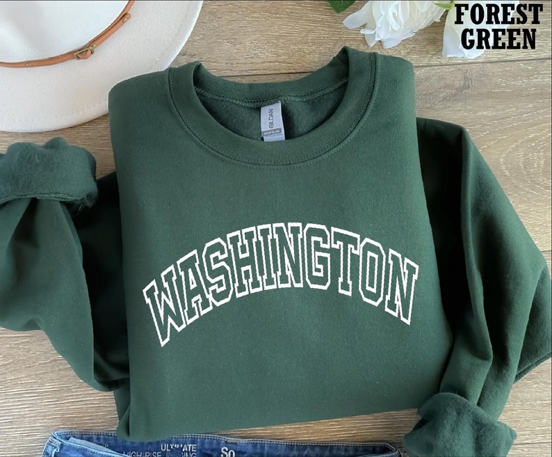 May include: Forest green sweatshirt with white text that reads "WASHINGTON" in an arched font.