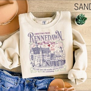 a white shirt with a picture of a castle on it