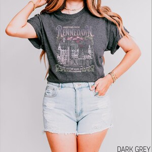 a woman wearing a black shirt and denim shorts