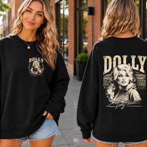 A woman wearing a black sweatshirt with a Dolly Portin graphic on the back.
