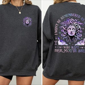 a woman wearing a sweatshirt with an image of a woman's face on it